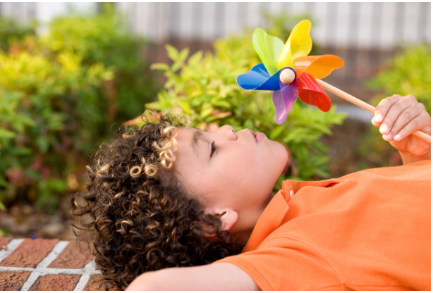 Child Blowing Pinwheelcropped.png