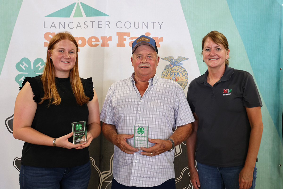 Recognition at the Lancaster County Super Fair: (L–R) Allison Walbrecht (Emerging Adult Volunteer) and Harry Muhlbach (Outstanding Adult Volunteer) with Extension Educator Tracy Anderson