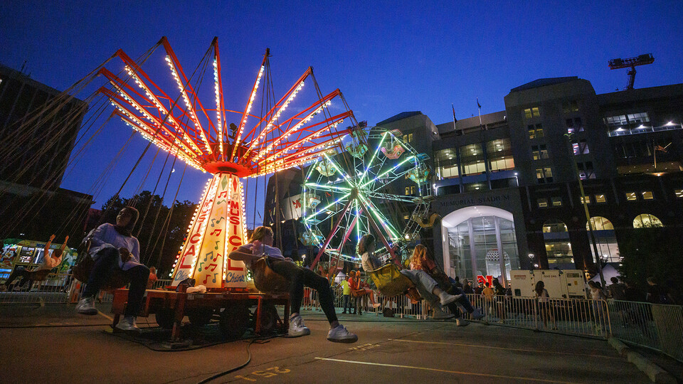 The Musical Chairs ride and Ferris wheel light up the East Stadium Plaza during the 2022 Cornstock Festival. The 2023 festival is 4 to 8 p.m. Oct. 27, again on the plaza. The event is free and open to the public. [Craig Chandler | University Communication