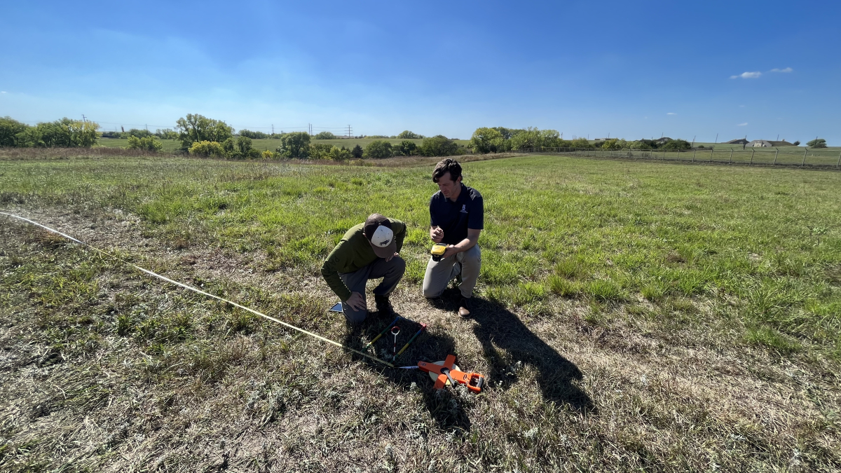 Dan Uden (right) helps Trace Stauble, a graduate student in agronomy, use GPS technology to collect grassland data.