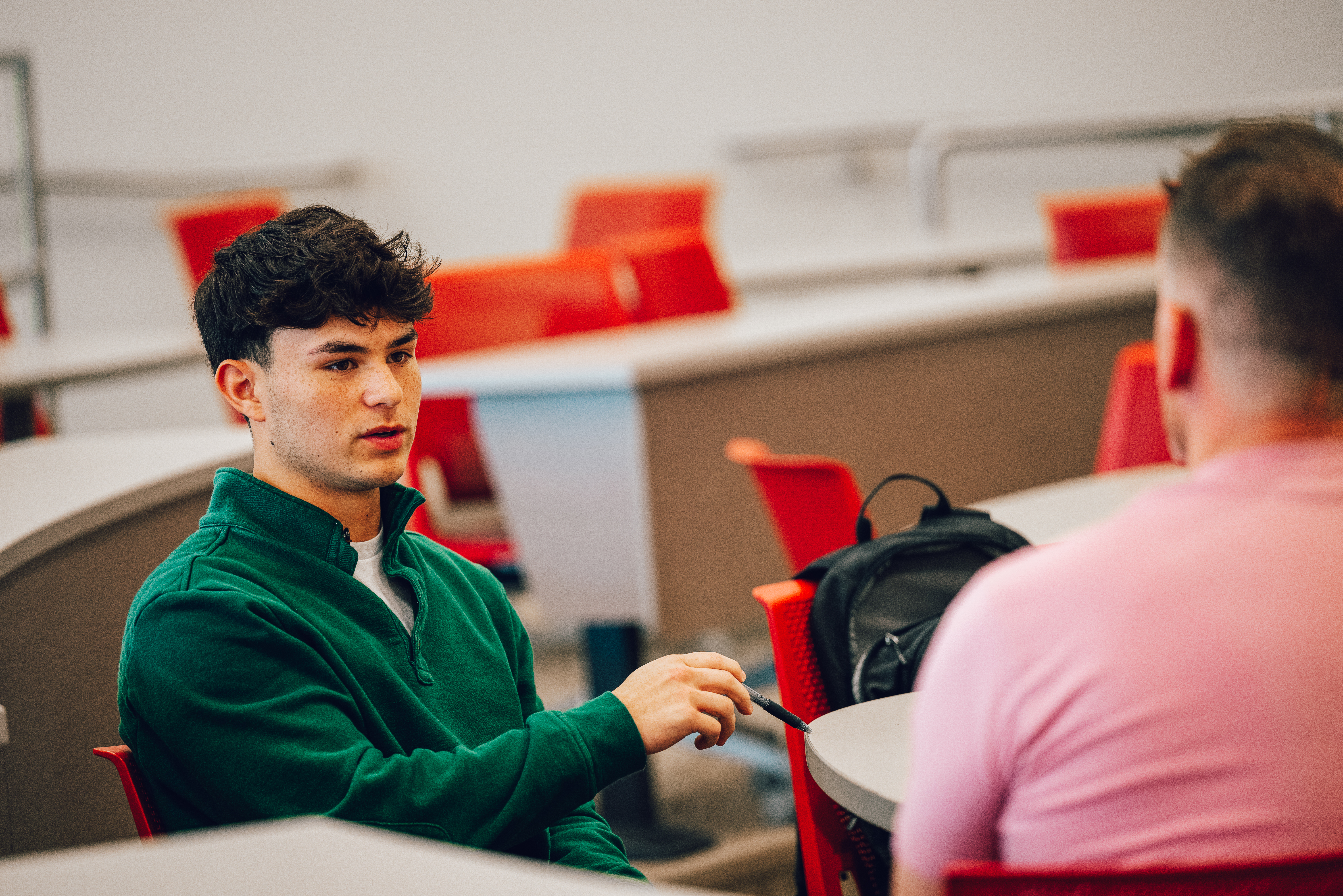 A student connects with a guest speaker during an entrepreneurship course