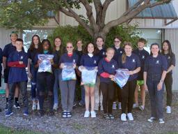 Teen Council members holding hygiene kits for the People's City Mission.