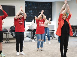 Students participate in an exercise along with their Emmy Award-winning professor, Julie Uribe