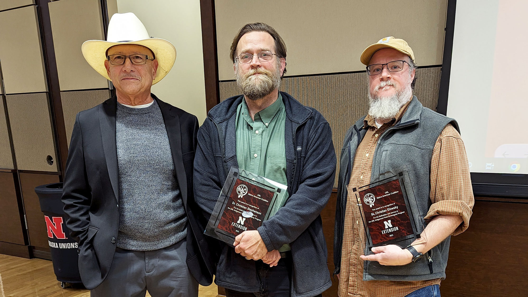 Ted Hibbeler (from left), honors Christian Elowsky and Christian Stephenson for their commitment and time to the Indigenous Youth Food Sovereignty Program.