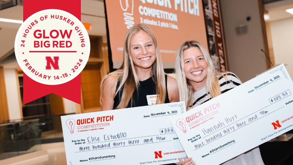 Elise Estudillo and Hannah Hurt pose with their checks after winning the 3-2-1 Quick Pitch Competition in November