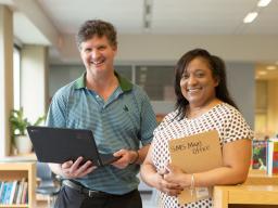 Two teachers in a library.