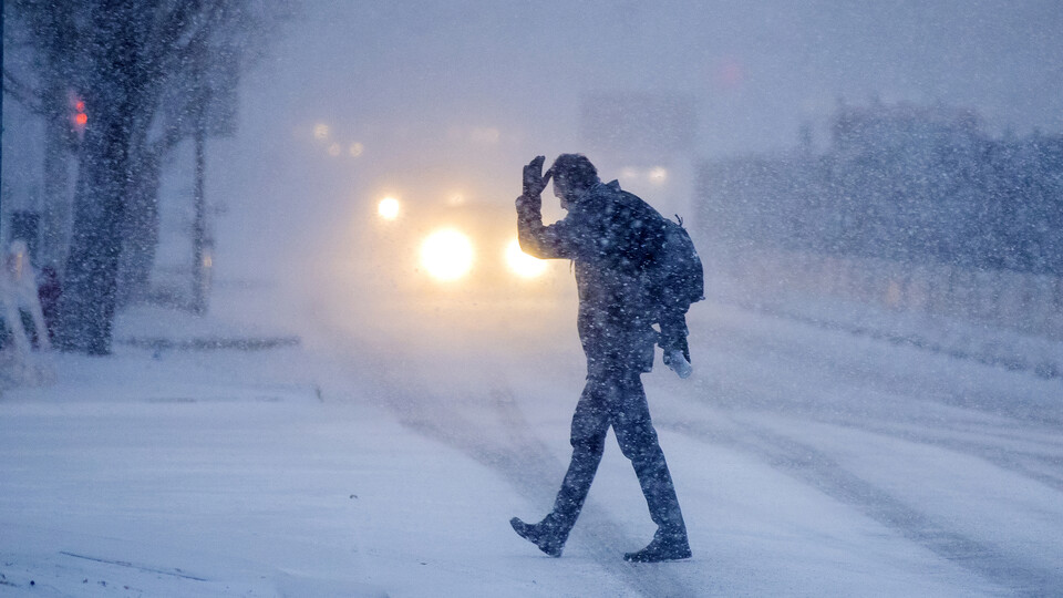 A person crosses a street during a Lincoln, Nebraska, blizzard in December 2019. Image Credit: Craig Chandler | University Communication and Marketing