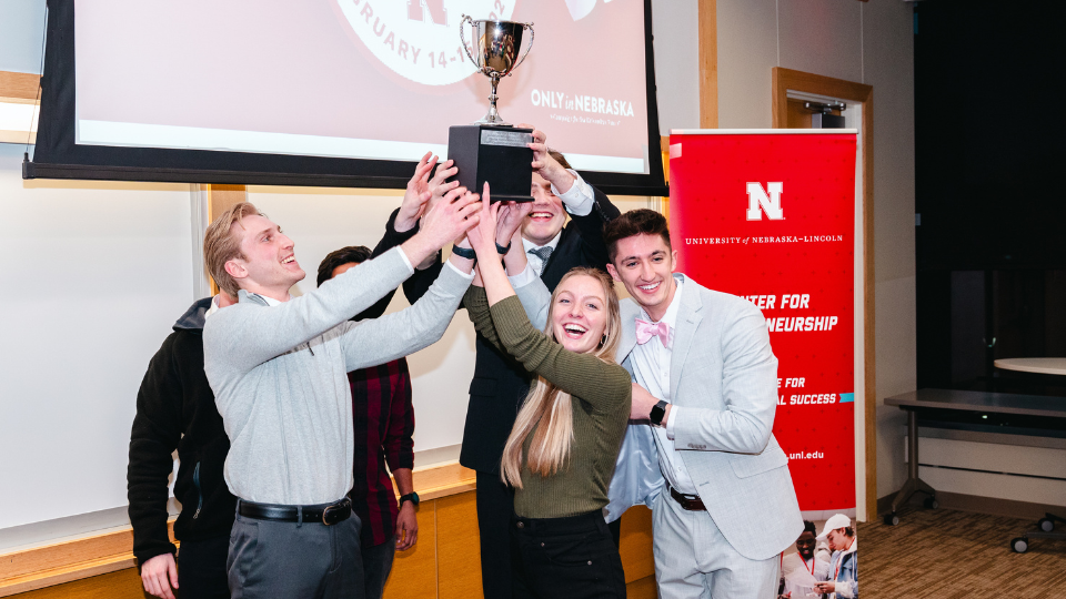 Paige Perrone and her teammates raise the first place trophy after winning the 48-Hour Challenge with her idea, Street Eats.