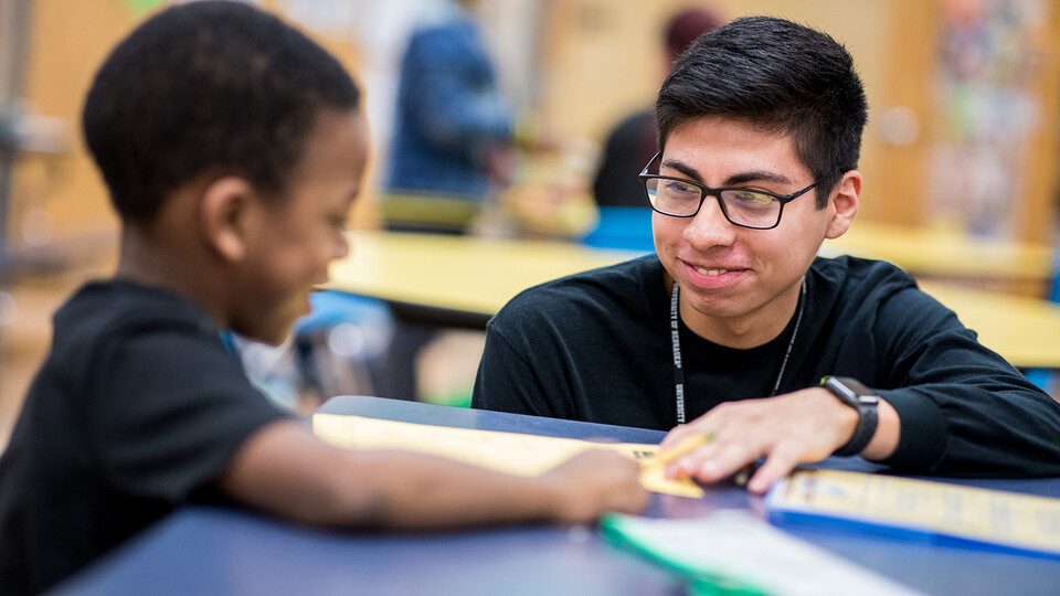 Nebraska’s Carlos Ortega works with a student at the Community Learning Center at Lincoln’s McPhee Elementary School. Photo credit: Just Jump Films 