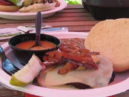 A "Jiffy Burger," made with peanut butter, bacon and Husker cheese, is typical fare at the cookouts.