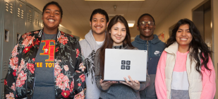 students holding laptop