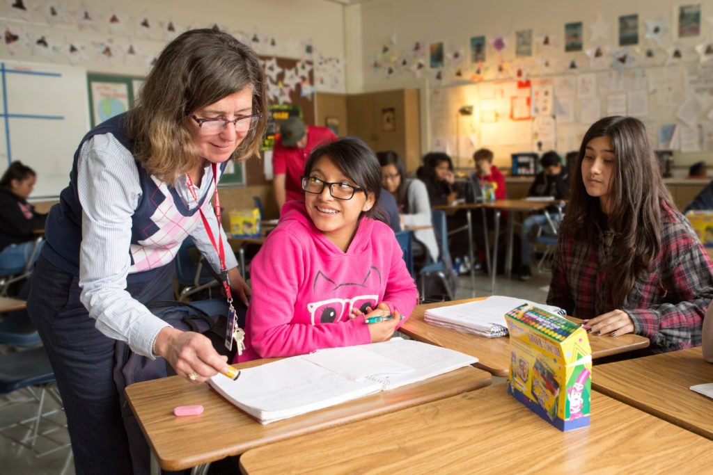 A teacher assisting a student.