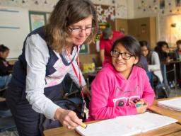 A teacher assisting a student.