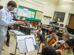 Dameer Gustafson, a junior music education major, teaches the UNL/LPS String Project second-year class in preparation for their concert April 17. Photo by Kristen Labadie/University Communication and Marketing.