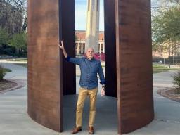 Paul Barnes stands inside the Richard Serra sculpture, “Greenpoint,” where he will perform a program of works by Philip Glass on May 1 to kick off Lincoln Calling.