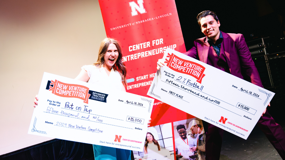 Miller and Sicilia Ayala pose with their checks after earning the top prizes in their respective brackets at the 2024 New Venture Competition on April 18.