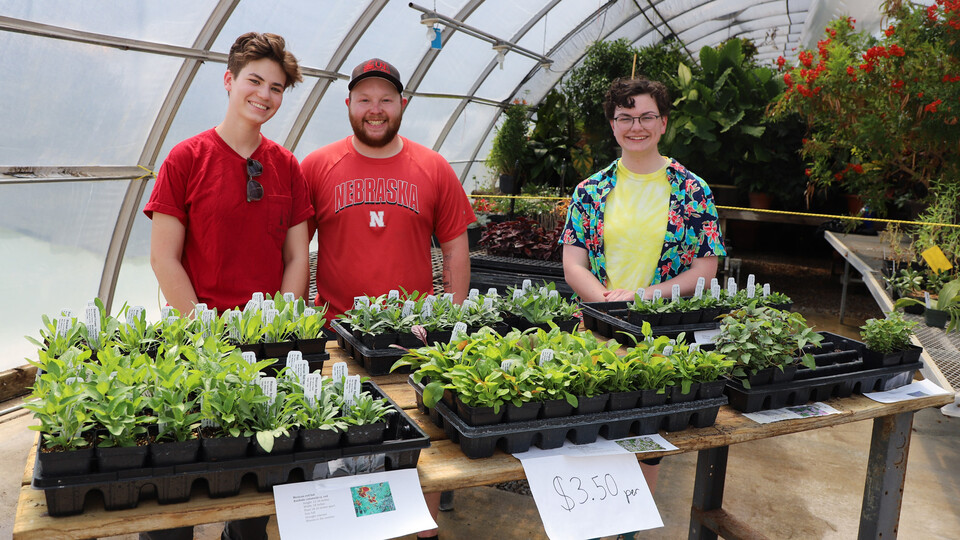 Lydia Regier (from left), Jacob VanDress and Caitlin Copenhaver sell native plants to the public to raise money for the club in 2023. 