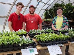 Lydia Regier (from left), Jacob VanDress and Caitlin Copenhaver sell native plants to the public to raise money for the club in 2023. 