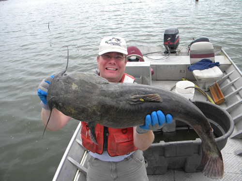 Kevin Pope with a flathead catfish captured from Branched Oak Lake. This fish was tagged by the Nebraska Game and Parks Commission to estimate the number of adult flathead catfish present in this reservoir. Photo by Keith Hurley.