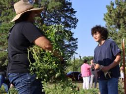 Timothy Thielen (left) talks with a member of the Turtle Island Indigenous Youth Growers.