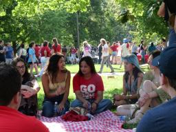 Sanskriti Duwaldi (center, in red shirt), a freshman acting major from Nepal and a member of the first cohort of the Global Arts Academy, visits with students at the Student Welcome Back Picnic on Aug. 22. Photo by Muskan Yadav.