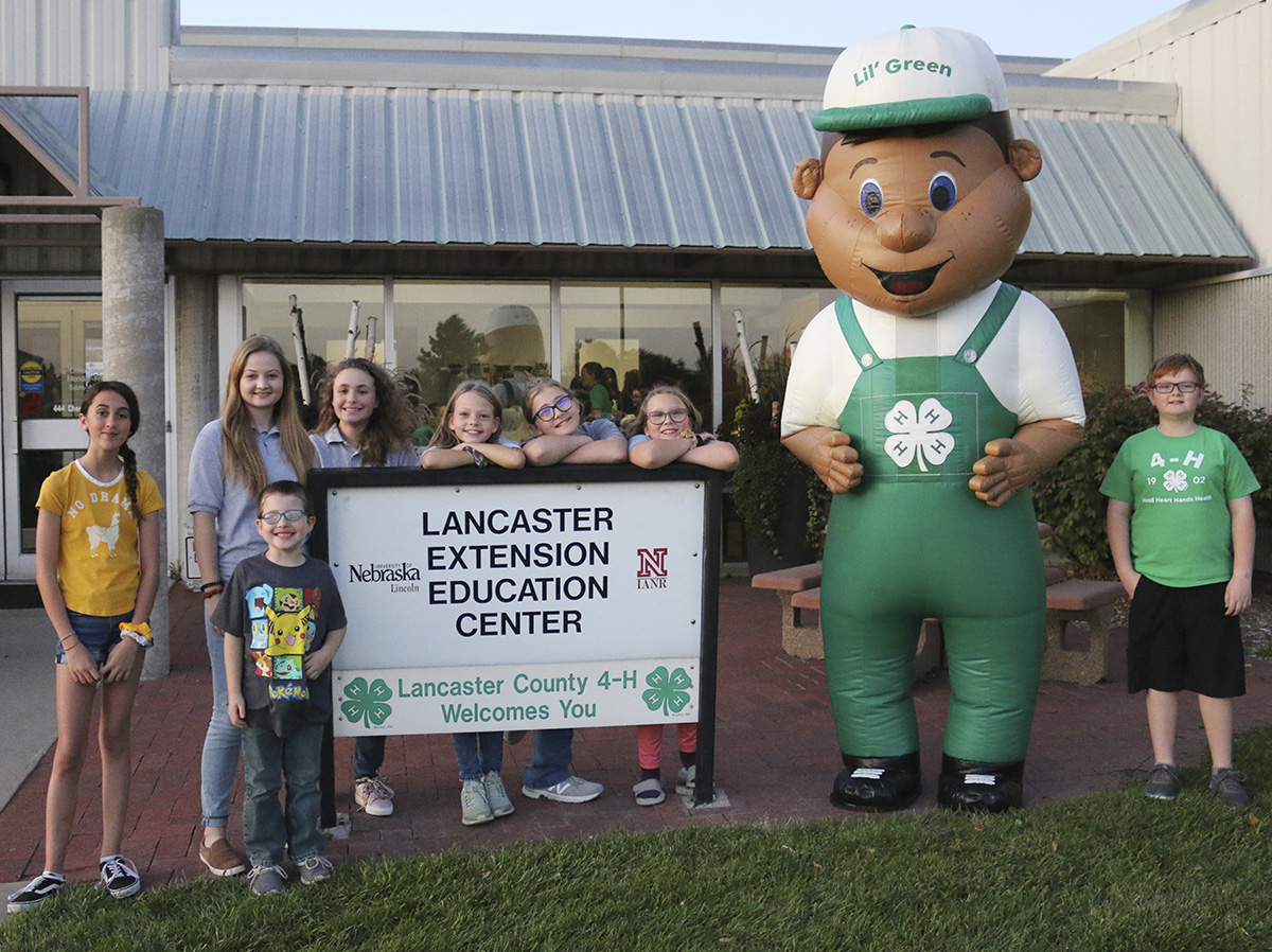 4-H mascot, Lil' Green, with 4-H'ers