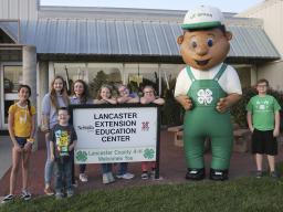 4-H mascot, Lil' Green, with 4-H'ers