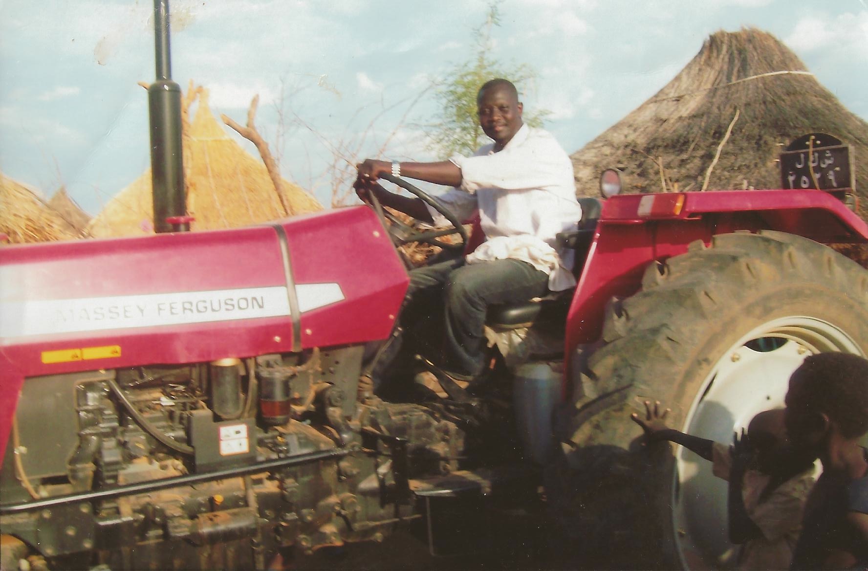 Local Humanitarian Younis Andindi with the tractor he provided to Sudan's Nuba Mountain community to help feed dozens of villages.