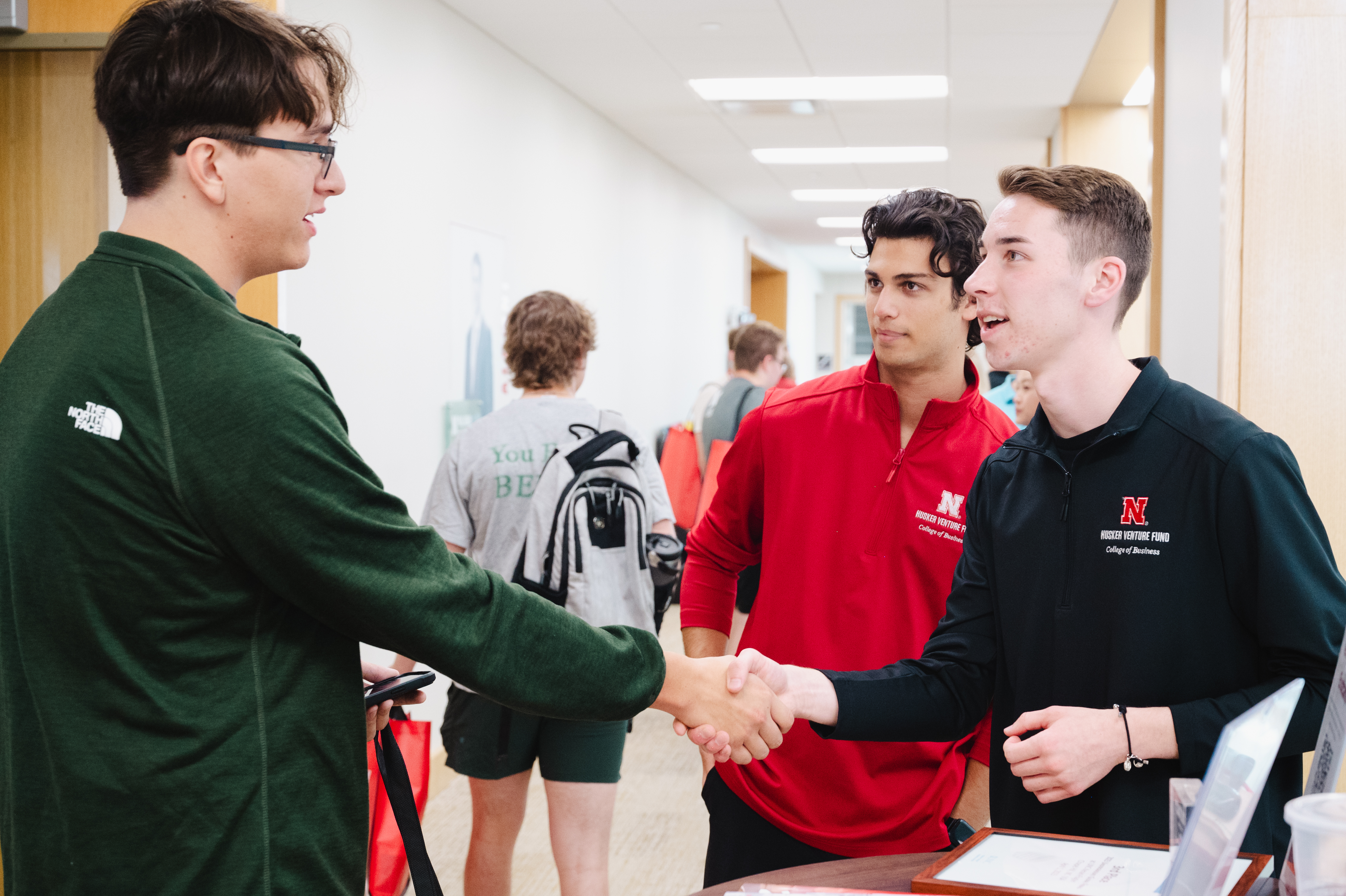 Husker Venture Fund members greet a prospective student at the Back to School Bash.