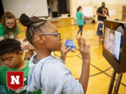 Ani'a Morris-Gordon interacts with Soham Patel using Beam technology to remote teach the class about nano technology and nano treated fabrics for Omaha school children in 2019. (Photo by Craig Chandler | UCOMM)