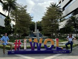 Charles Major and Megan Kolbe stand in front of the #IWOL (Infosys Way of Life) sign on the Infosys campus in India. Photo courtesy of Charles Major.