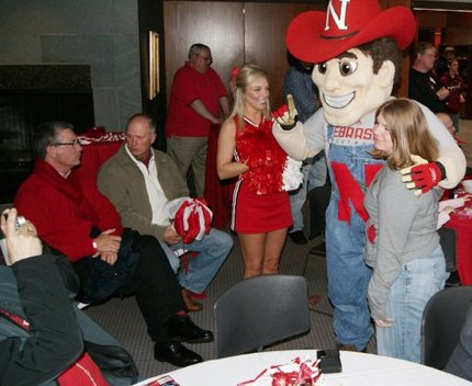 A Husker fan gets her photo taken with Herbie Husker during the 2011 Big Red Weekend.