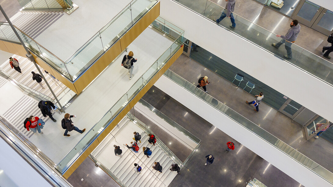 Students move through the hallways and stairwell within the College of Engineering's Kiewit Hall. Facility updates, like the addition of Kiewit Hall, are among the reasons the university improved its U.S. News and World Report ranking.