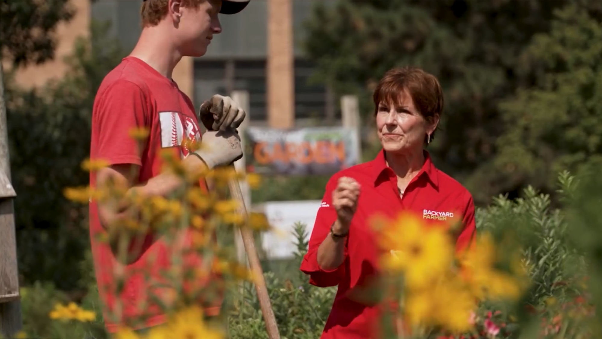 Cory Schumacher (left) and Kim Todd discuss work to be done in the Backyard Farmer Garden on East Campus.