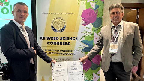 Goran Malidza, president of the Serbian Weed Science Society (left), awards Stevan Z. Knezevic with the a Certificate of Appreciation on Sept. 24 during the 12th Serbian Weed Science Society Conference in Serbia.