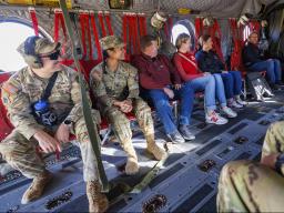 Lt. Col. Tom Slykhuis takes a photo of the cadets (from left) Colten Stevens and Alyssa Batista, and UNL’s Justin Chase Brown, Erin Burnette, and Becka Neary-DeLaPorte in the Chinook helicopter before takeoff at Nebraska Innovation Campus.