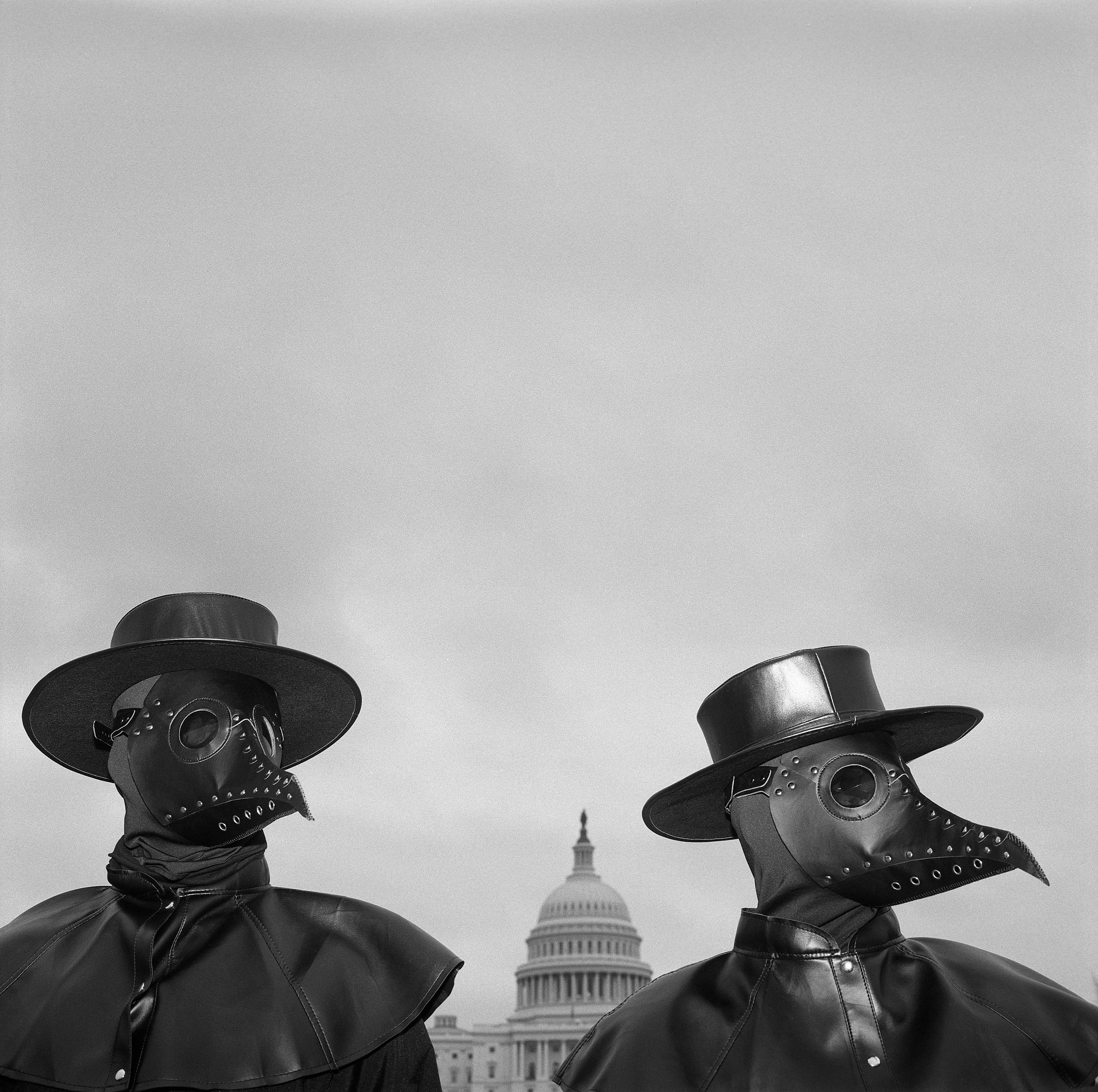 Two activists wear beaked masks like doctors wore in the 17th century during times of plague, seeking to draw the attention of spectators around Capitol Hill. Their message: Refusing to be vaccinated will prolong the COVID-19 pandemic. © Louie Palu