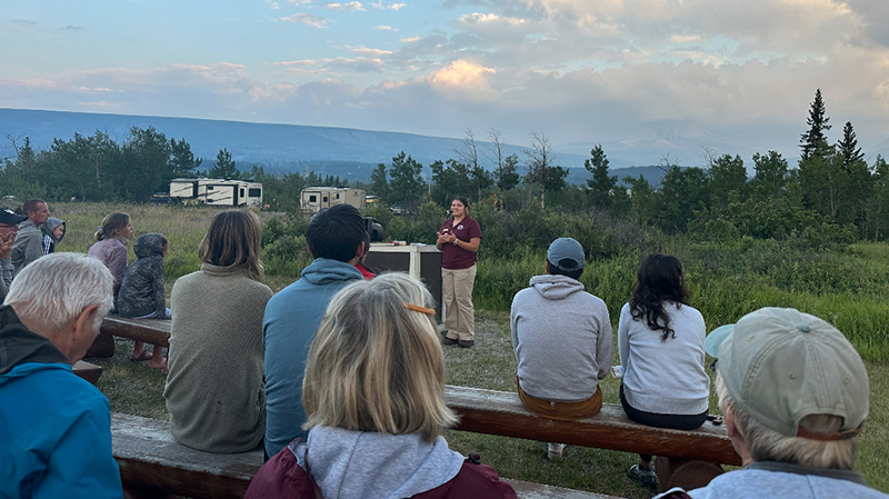 Madison Martinez, a senior in the School of Natural Resources majoring in fisheries and wildlife and applied science, presents about animal senses to summertime visitors at Glacier National Park. 