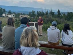 Madison Martinez, a senior in the School of Natural Resources majoring in fisheries and wildlife and applied science, presents about animal senses to summertime visitors at Glacier National Park. 