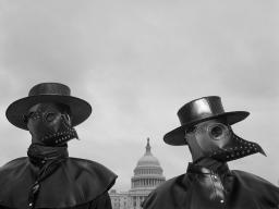 Two activists wear beaked masks like doctors wore in the 17th century during times of plague, seeking to draw the attention of spectators around Capitol Hill. Their message: Refusing to be vaccinated will prolong the COVID-19 pandemic. © Louie Palu