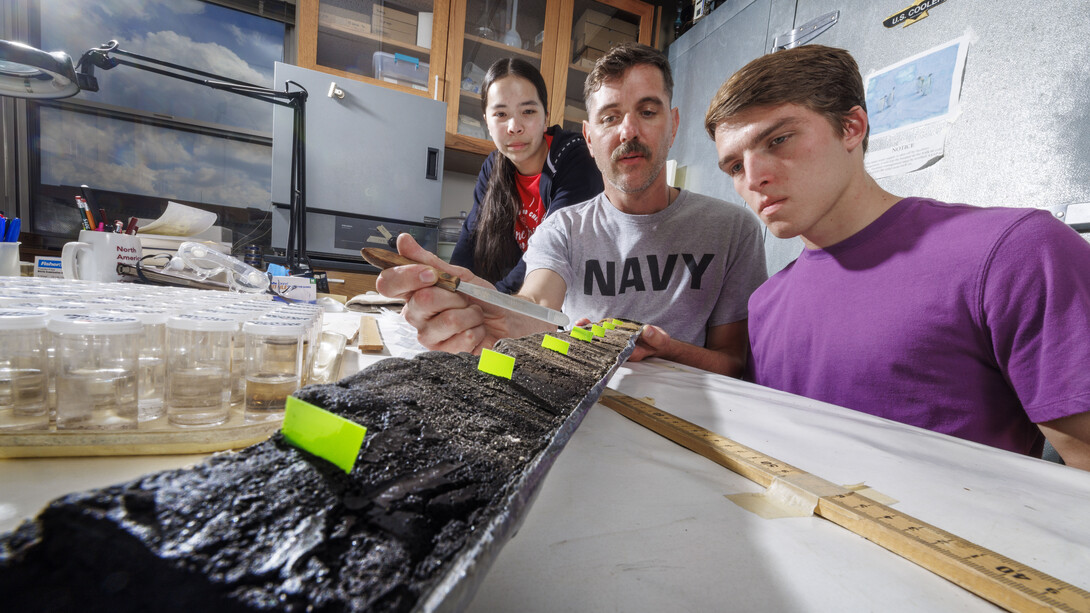 Doctoral student Jim Benes and UCARE students Jasmine Pham and Joe Stalder with charcoal samples from the Nebraska Sandhills.