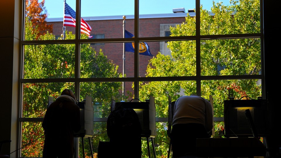 Individuals at a polling place in the Nebraska Union.