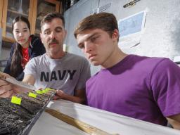 Doctoral student Jim Benes and UCARE students Jasmine Pham and Joe Stalder with charcoal samples from the Nebraska Sandhills.