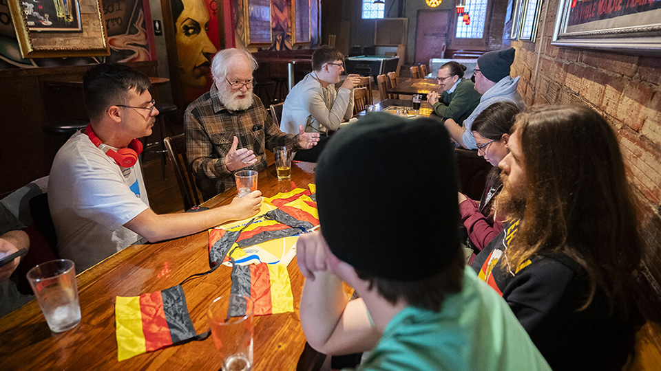 Robert Shirer, emeritus associate professor of German (second from left), talks with students at Yia Yia’s on O Street during a German conversations table. [Jordan Opp | University Communication and Marketing]