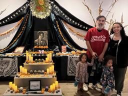 Angelica Tapia (right) with Elvira Hernandez’s nephew, Victor Hernández Chávez, and his family next to the altar honoring Elvira Hernandez at the Smithsonian’s National Museum of American Latino Día de los Muertos installation. Courtesy photo.