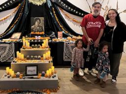 Angelica Tapia (right) with Elvira Hernandez’s nephew, Victor Hernández Chávez, and his family next to the altar honoring Elvira Hernandez at the Smithsonian’s National Museum of American Latino Día de los Muertos installation. Courtesy photo.