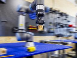 A robotic arm is programmed to stack blocks at Nebraska Innovation Studio. The Universal Robot CORE Training is now offered as a digital badge course.