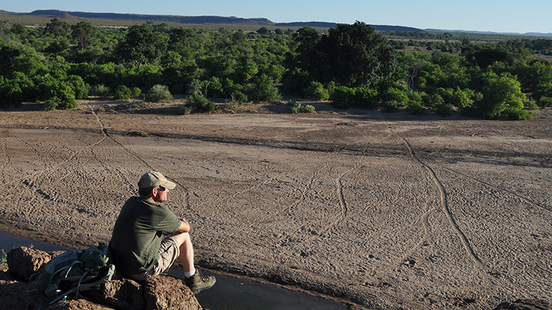 John Carroll enjoys a quiet moment overlooking the Motloutse River in the Northern Tuli Game Reserve, Botswana. He has hosted study abroad trips to Botswana and South Africa almost every year since 2000.