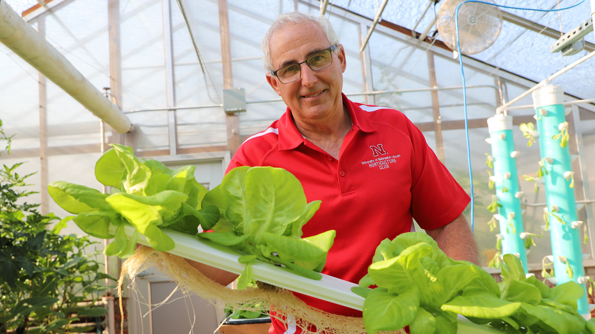 University of Nebraska–Lincoln’s Stacy Adams, professor of practice in agronomy and horticulture, shows off 5-week-old bib lettuce grown by a hydroponics system on floating rafts using the deep flow technique in an East Campus greenhouse.