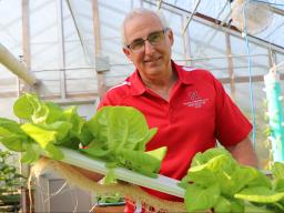 University of Nebraska–Lincoln’s Stacy Adams, professor of practice in agronomy and horticulture, shows off 5-week-old bib lettuce grown by a hydroponics system on floating rafts using the deep flow technique in an East Campus greenhouse.